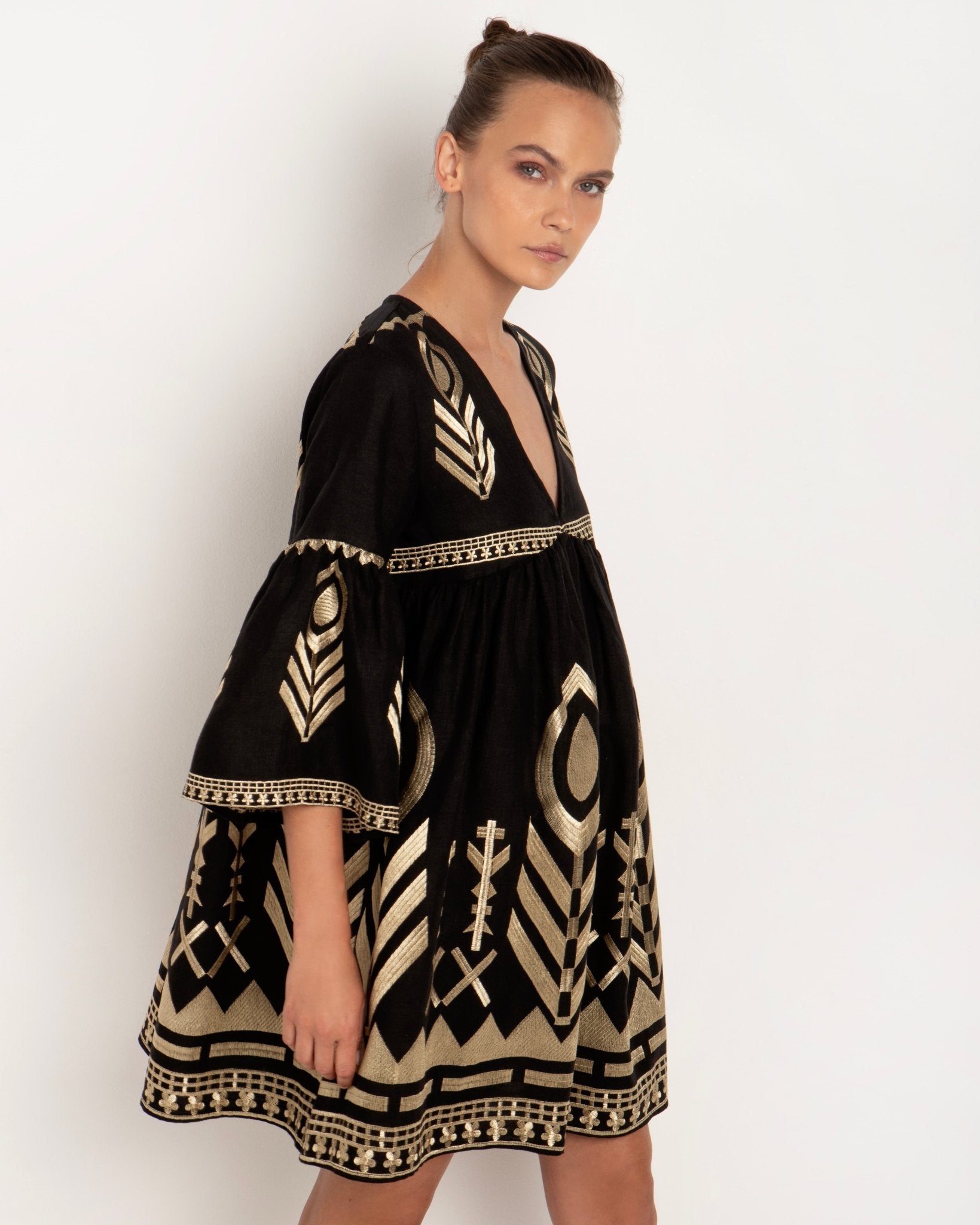 Greek Archaic Kori Black & Gold Feather Embroidered Dress. Available at Pasha Living