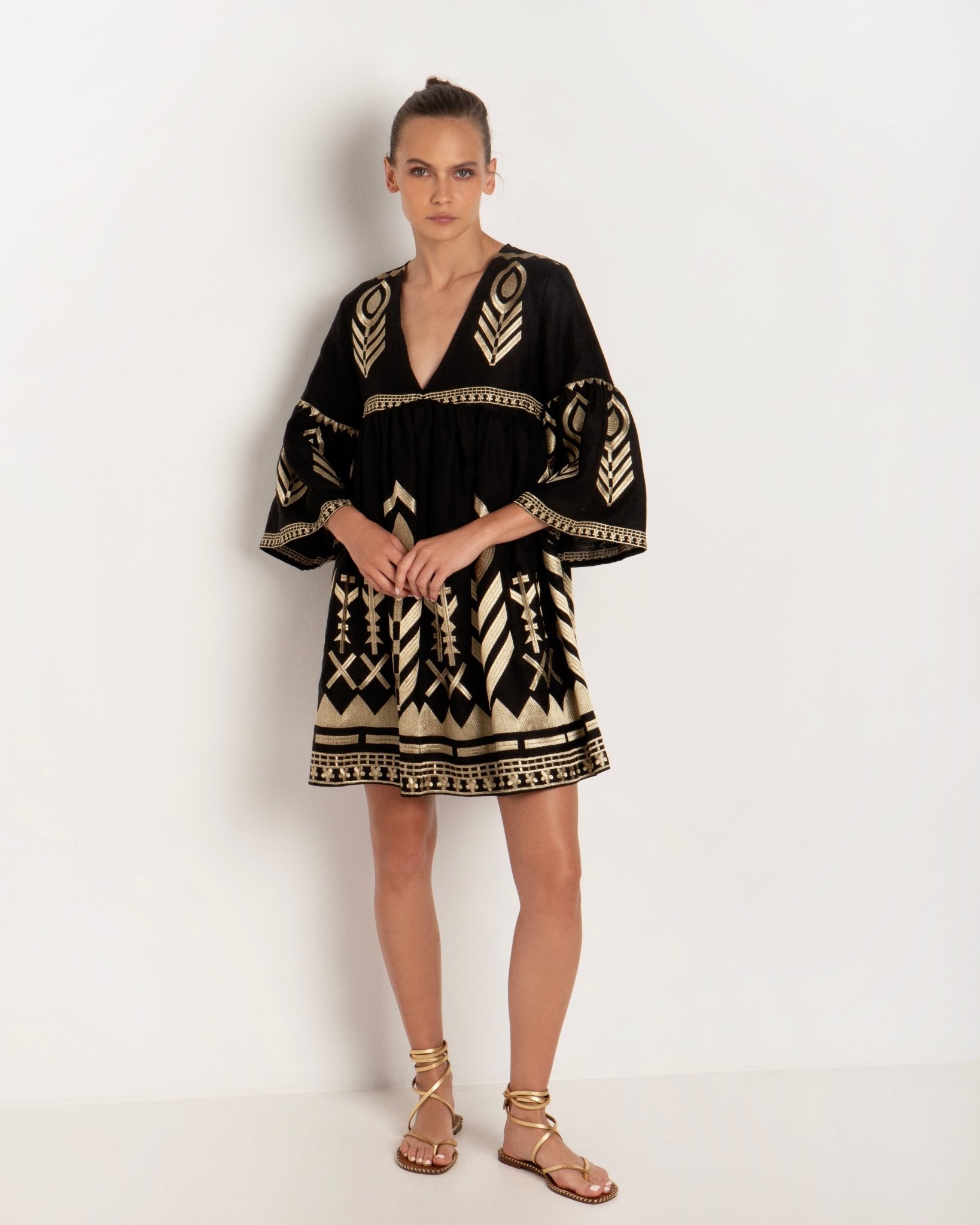 Greek Archaic Kori Black & Gold Feather Embroidered Dress. Available at Pasha Living