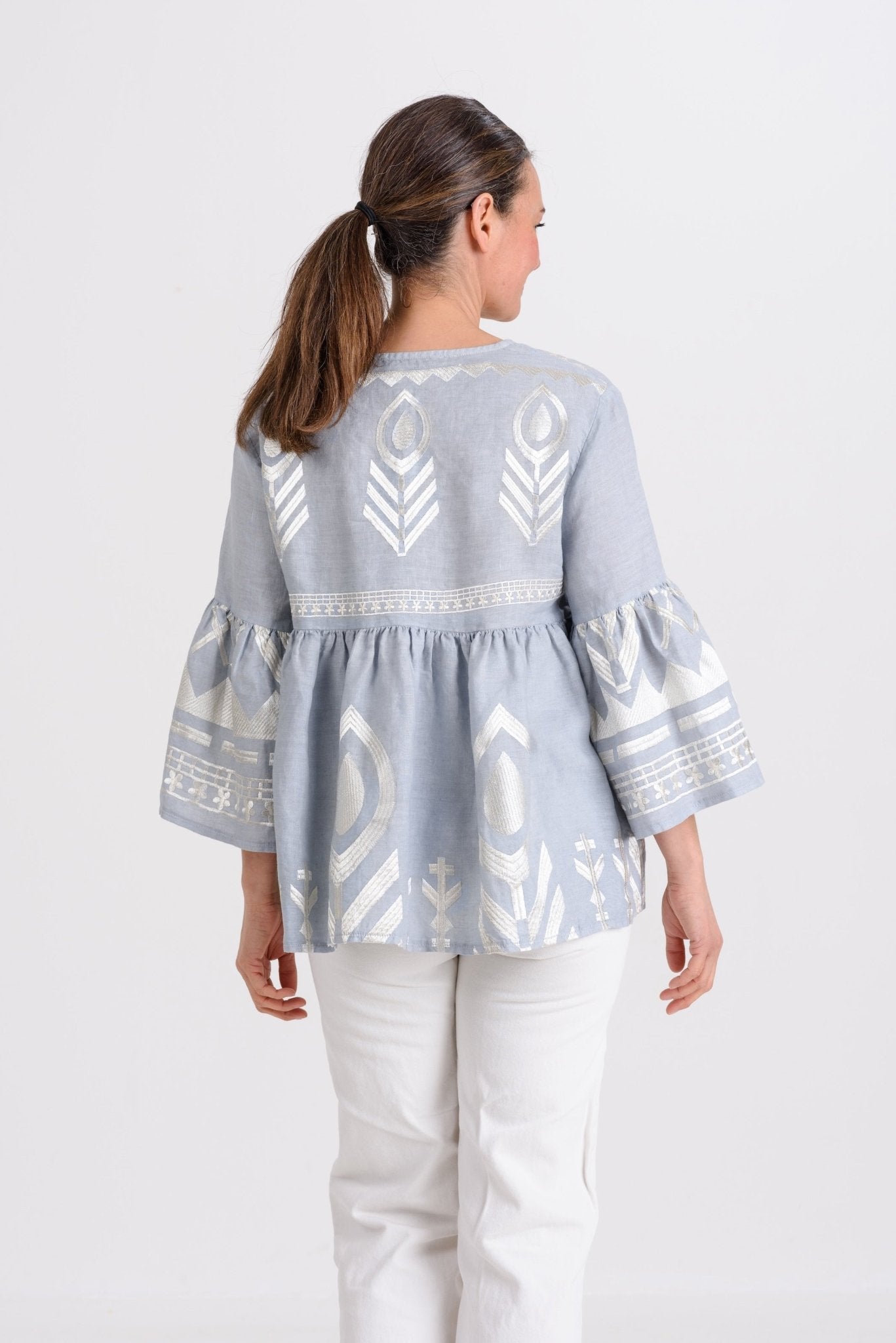 Greek Archaic Kori Short Feather Bell Sleeve Blouse | Grey & Champagne. Available at Pasha Living