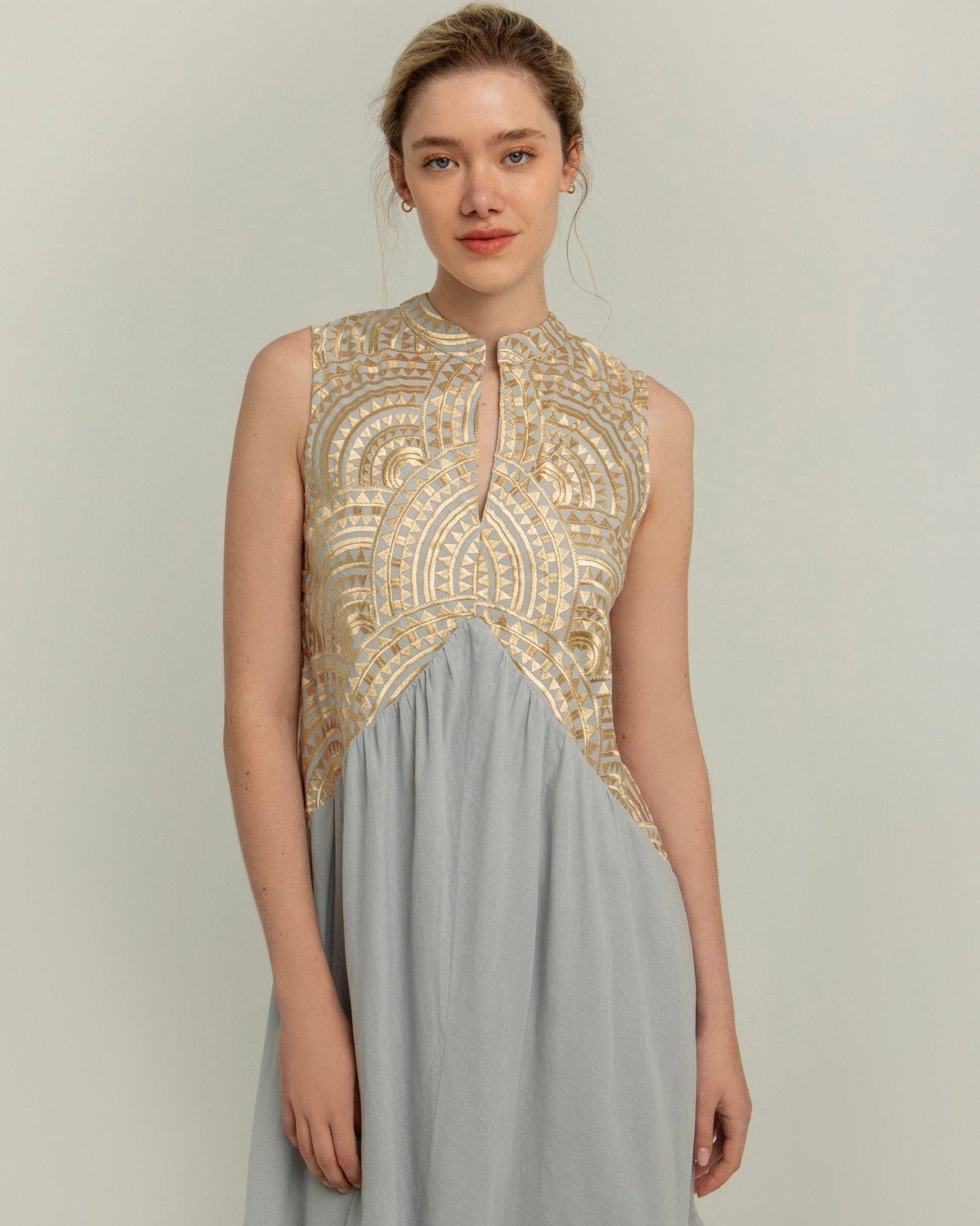 Greek Archaic Kori Sleeveless Voile Maxi Dress | Light Grey & Gold. Available at Pasha Living